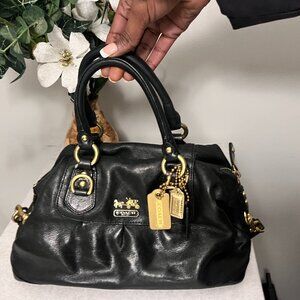 Classic Black Coach Handbag with Gold Accents & Signature Tag